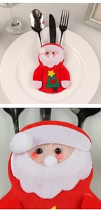 Detailopname van de kerstman bestekhouder van vilt met een pluche baard en blosjes.