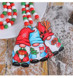 Close-up of Christmas wooden gnome ornaments with festive red, white, and green bead garland
