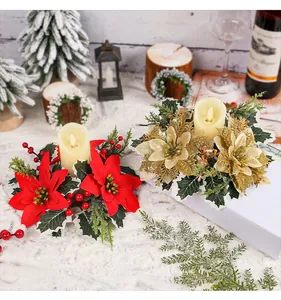 Close-up of red and gold poinsettia candle ring decorations with faux candles.