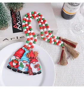 Festive Christmas wooden bead garland with gnome pendants and red, white, and green beads with tassels.