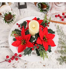 Elegant artificial Christmas poinsettia candle ring with LED pillar candle on plate