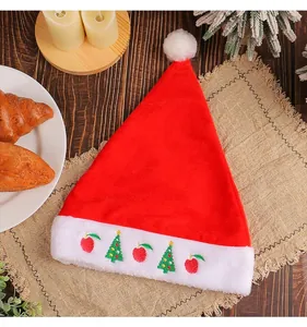 Close-up view of the embroidered Christmas hat with festive tree and apple patterns