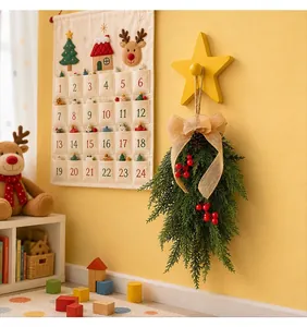 Christmas cedar swag with red berries and burlap bow hanging in a festive nursery