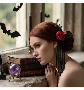 Detail view of a Gothic Halloween hair clip with a red rose and skeleton hand.