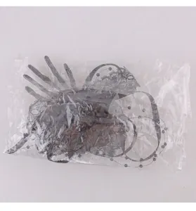 Detailed view of a Halloween skeleton hand hair clip with lace in its clear plastic packaging