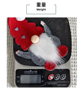 Detailed view of gnome-shaped Christmas felt cutlery holder weighing 8 grams on scale