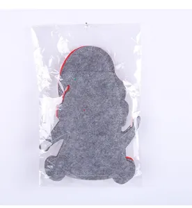 Rear view of Christmas gnome felt cutlery bag inside transparent plastic packaging