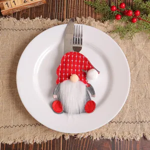 Festive Christmas gnome felt cutlery holder placed on a white plate for holiday table decor