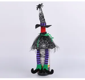Close-up of Halloween witch-themed wine bottle cover featuring spiderweb design