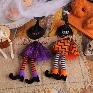Festive Halloween witch hat and long-legged doll wine bottle covers for table decor.