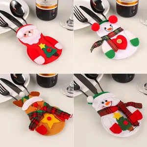 Kerstbestekhouders set met kerstman en sneeuwpop voor een feestelijke tafeldecoratie