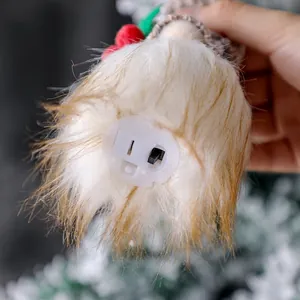 Bottom switch detail of a glowing Christmas gnome plush ornament for tree decoration