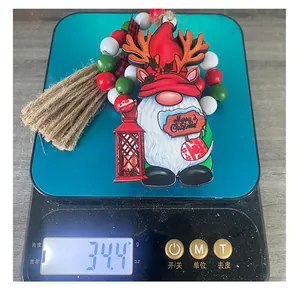 Weight measurement of a wooden Christmas gnome hanging ornament showing 34.4 grams