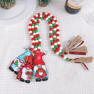 Handcrafted Christmas wooden bead garland with festive gnomes and jute tassels.
