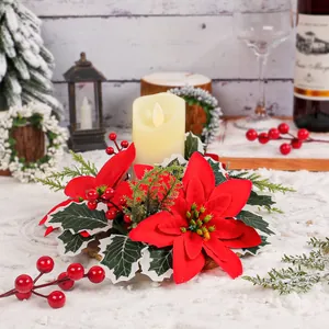 Festive Christmas poinsettia flower candle holder with LED candle on snowy winter background