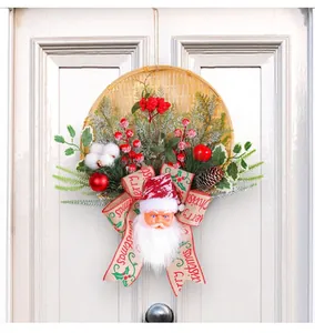 Close-up of festive Christmas bamboo basket wreath with Santa Claus and red berries