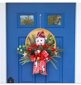 Handmade Christmas wreath with snowman and red ribbon hanging on a blue door