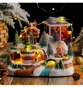 Detailed view of resin gingerbread music box with rotating train and warm LED lights
