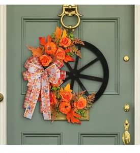 Detailed close-up showing decorative faux pumpkins and roses on the wagon wheel wreath.