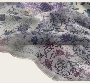 Detailed close-up of a floral printed cotton scarf with delicate vintage patterns.