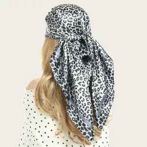 Detailed macro view of 90cm leopard print satin square scarf used as a stylish fashion headwrap