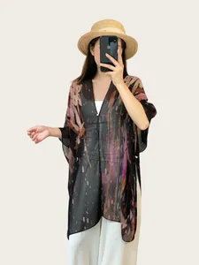 Modelo asiática con un chal de protección solar de estilo bohemio y étnico
