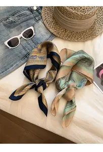 Close-up of vintage paisley silk scarves in khaki and green with holiday accessories