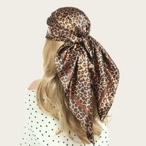 Detailed back view of a satin square scarf with leopard print tied as a headscarf