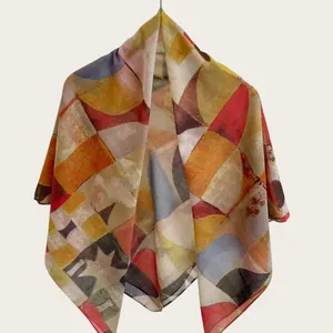 Close-up detail of soft cotton silk square scarf with colorful abstract geometric patterns