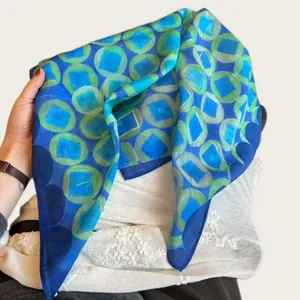 Lightweight blue silk scarf with green geometric circle print for summer fashion.