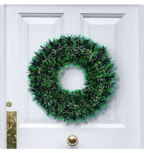 Detail shot of the 42cm green and black tinsel Christmas wreath on a white door.