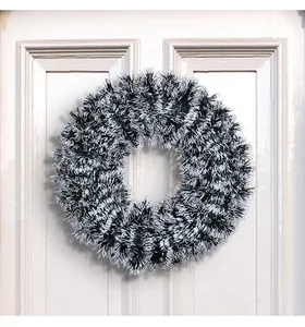 Close-up of a 42cm black and white Christmas tinsel wreath hanging on a door
