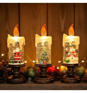 Detailansicht von drei weihnachtlichen LED-Kerzen mit Schneemann, Weihnachtsmann und Baum
