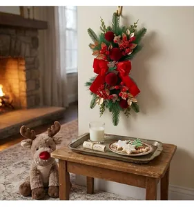 Elegant Christmas wall swag with red velvet bow and berries in cozy fireplace scene