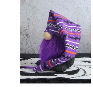 Close-up side view of a Halloween plush gnome with a long purple beard and knitted hat