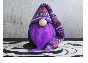 Macro view of a purple bearded Halloween gnome wearing a knitted patterned long hat