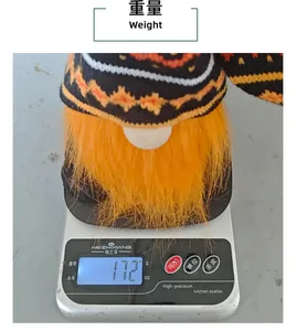 Detailed view of the Halloween knitted gnome plush doll being weighed at 172g on a scale.