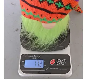 Detail view of the green beard Halloween gnome doll showing its weight of 172g on a scale