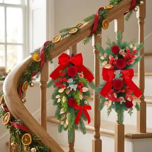 Elegant Christmas swags with red velvet bows and reindeer decor on a staircase banister