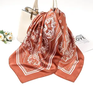 Macro detail of the 90cm rust brown satin square scarf with white paisley pattern