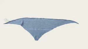 Detailed macro view of the minimalist light blue knitted hollow-out shawl texture