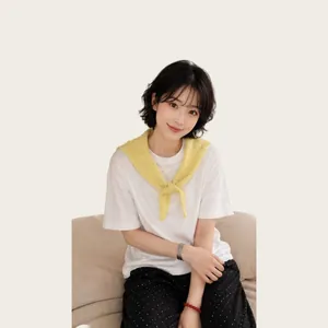 Asian model styling a minimalist yellow knitted hollow triangle scarf over white t-shirt