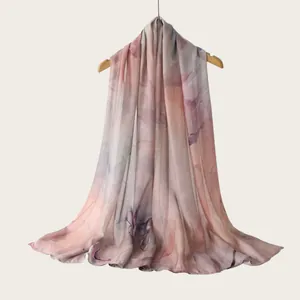 Close-up detail of a soft rayon scarf featuring an artistic watercolor gradient print