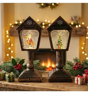 Zwei vintage bronzene Weihnachts-Schneekugel-Laternen mit Weihnachtsmann und Baum im Zimmer.