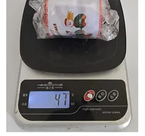 Measurement showing 47g weight of Christmas Santa Claus patterned ribbon roll