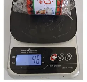 Digital scale showing the weight of a roll of Christmas ribbon at 46 grams