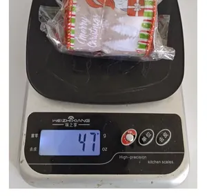 Detailed shot of a Christmas ribbon roll on a digital scale showing weight of 47 grams