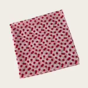 Detailed view of a soft light pink cotton-linen square scarf featuring a cute red tomato print