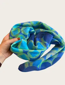 Detailed view of lightweight blue and green geometric pattern silk scarf for women
