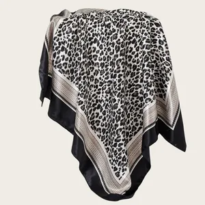 Detail of leopard print satin scarf showing elegant drape and silk-like texture